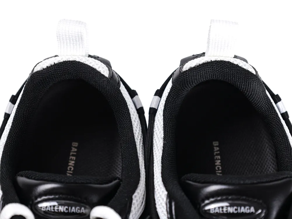 Black and white sneakers with fabric loops, featuring brand name on insoles.