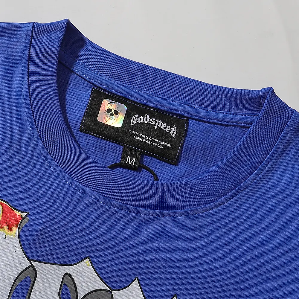 Detailed close-up of the tee's neck label, featuring wash care instructions and subtle brand branding in a clean, minimalist typography