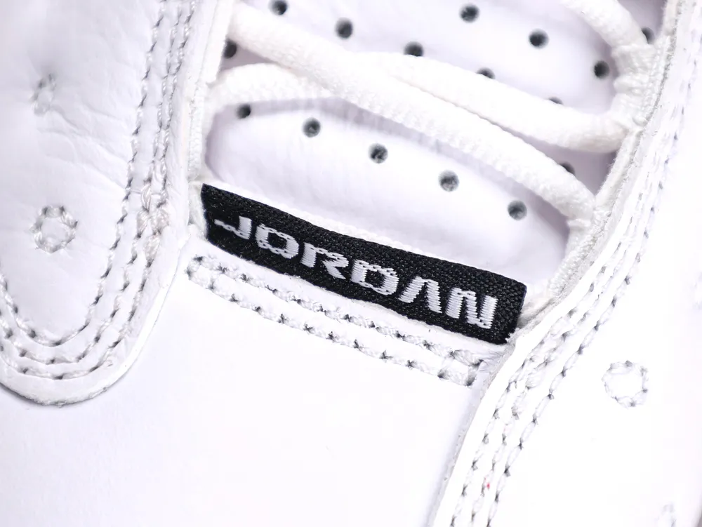 Close-up of white leather shoe with black embroidered label near laces.