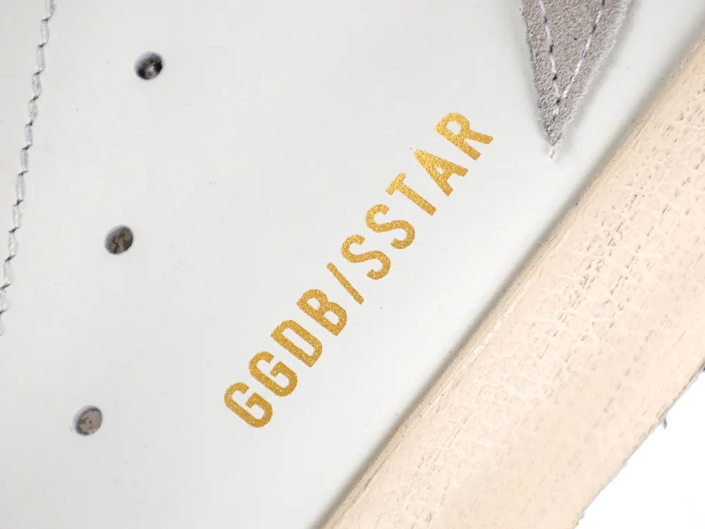 Gold GGDB/SSTAR branding on white leather sneaker