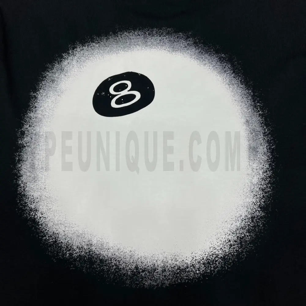 Detailed shot capturing the graphic print on the black tee's back panel.