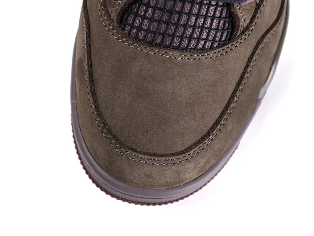 Close-up of brown suede shoe showing detailed stitching and textured black mesh panel.