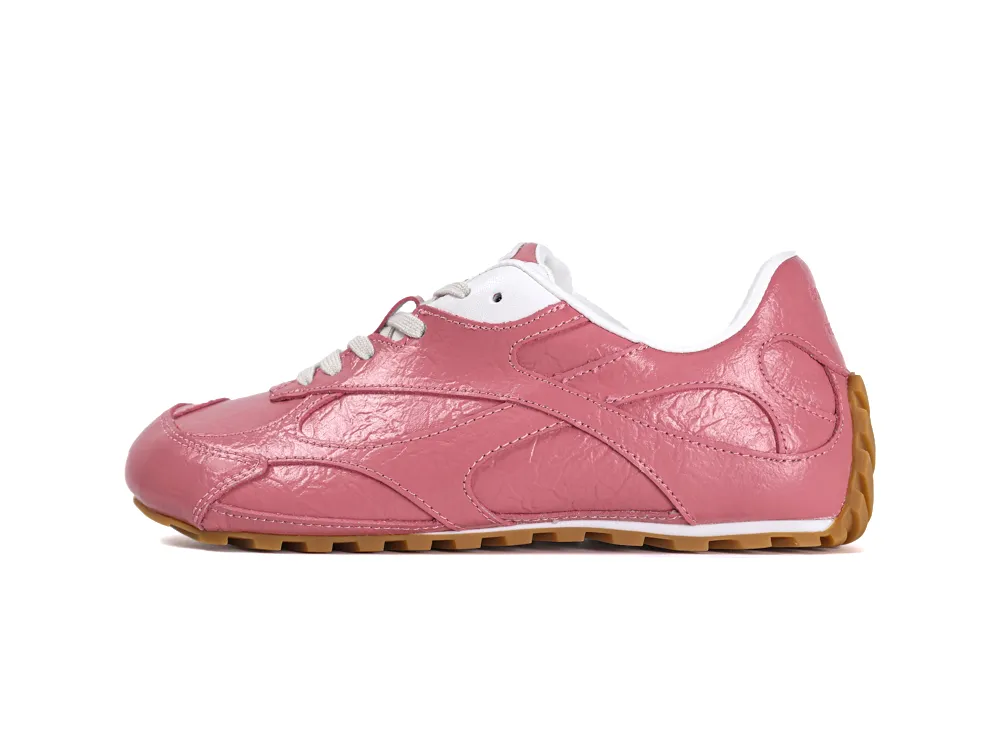 Medial side view of the left sneaker highlighting the textured pink leather overlays and slim athletic silhouette.