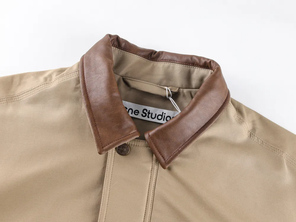 Tan fabric jacket with a brown leather collar, close-up view.