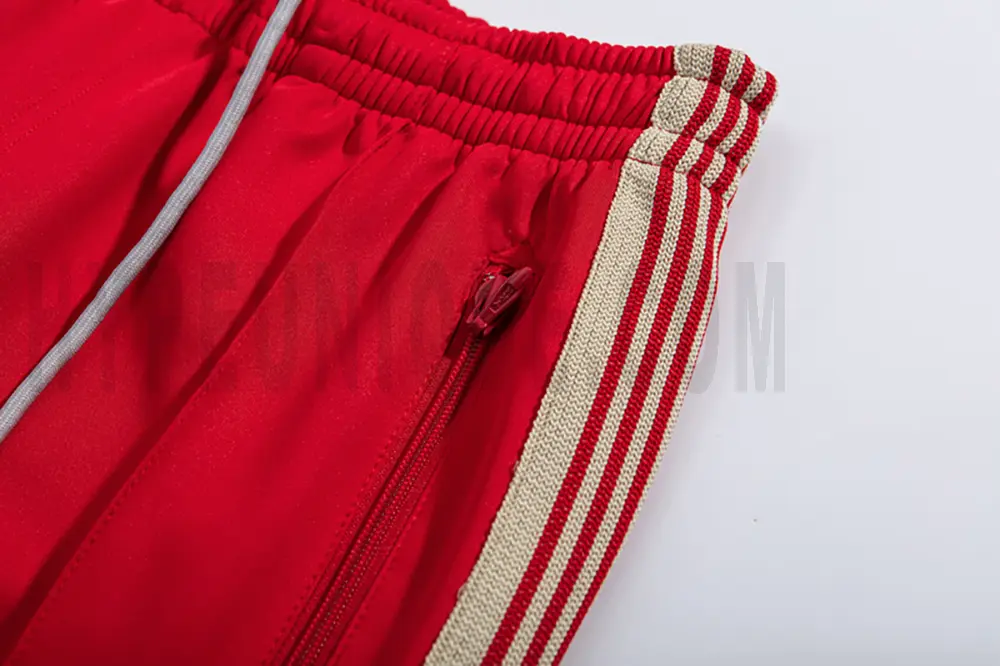 Close-up detail of the track pants pocket.