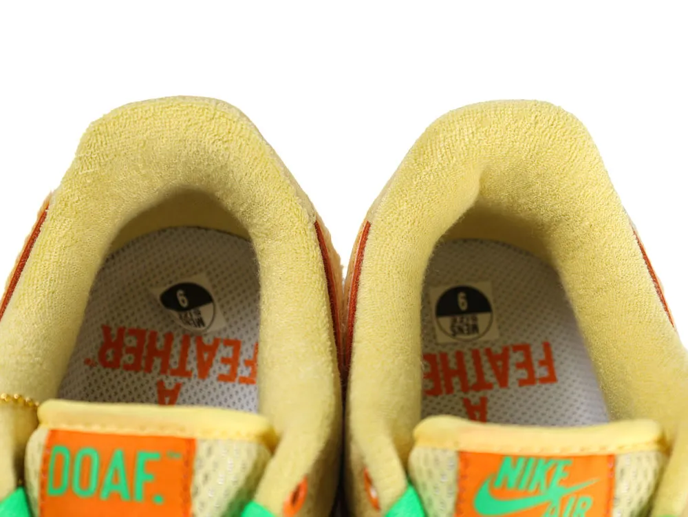 Yellow suede sneaker collars with green accents and visible size label on the insole.