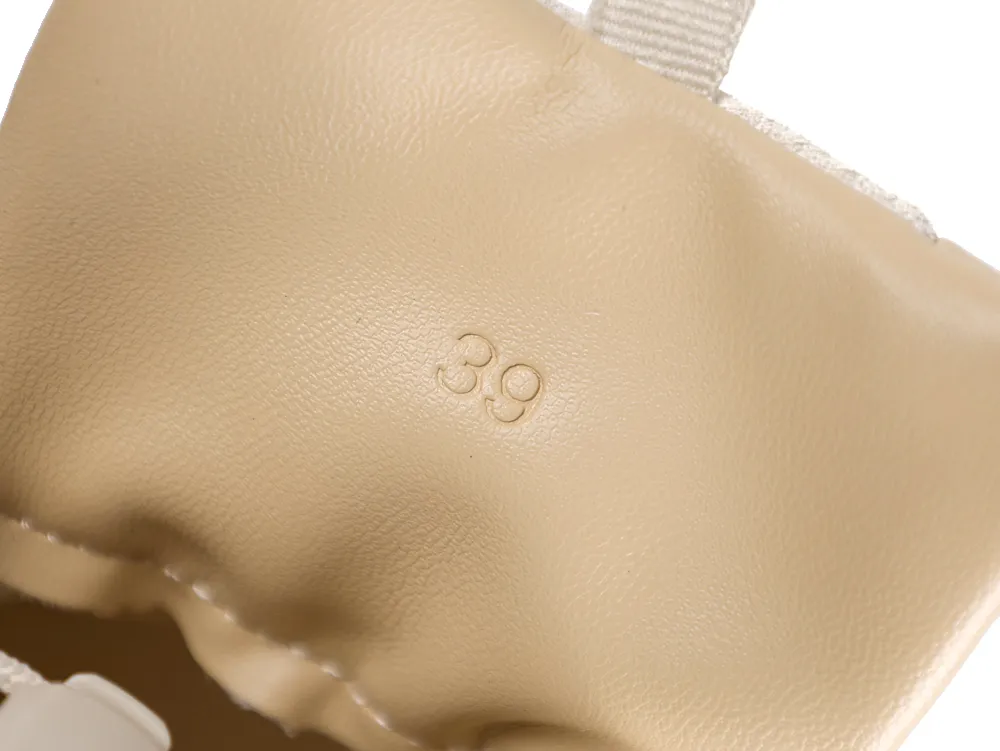 Beige leather product with embossed number 39, featuring fabric detail.