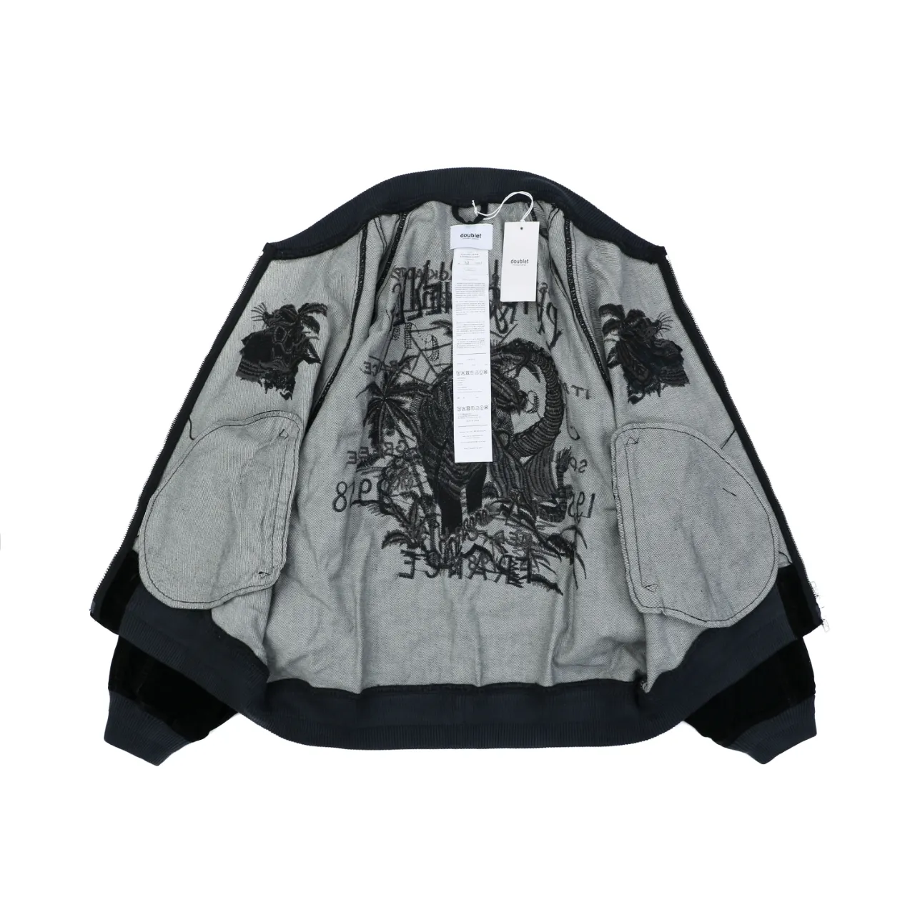Jacket lining with black embroidery and two pockets, displaying tag details.