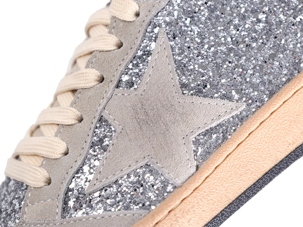 Side view of Golden Goose Ball Star sneaker with grey suede star on silver glitter