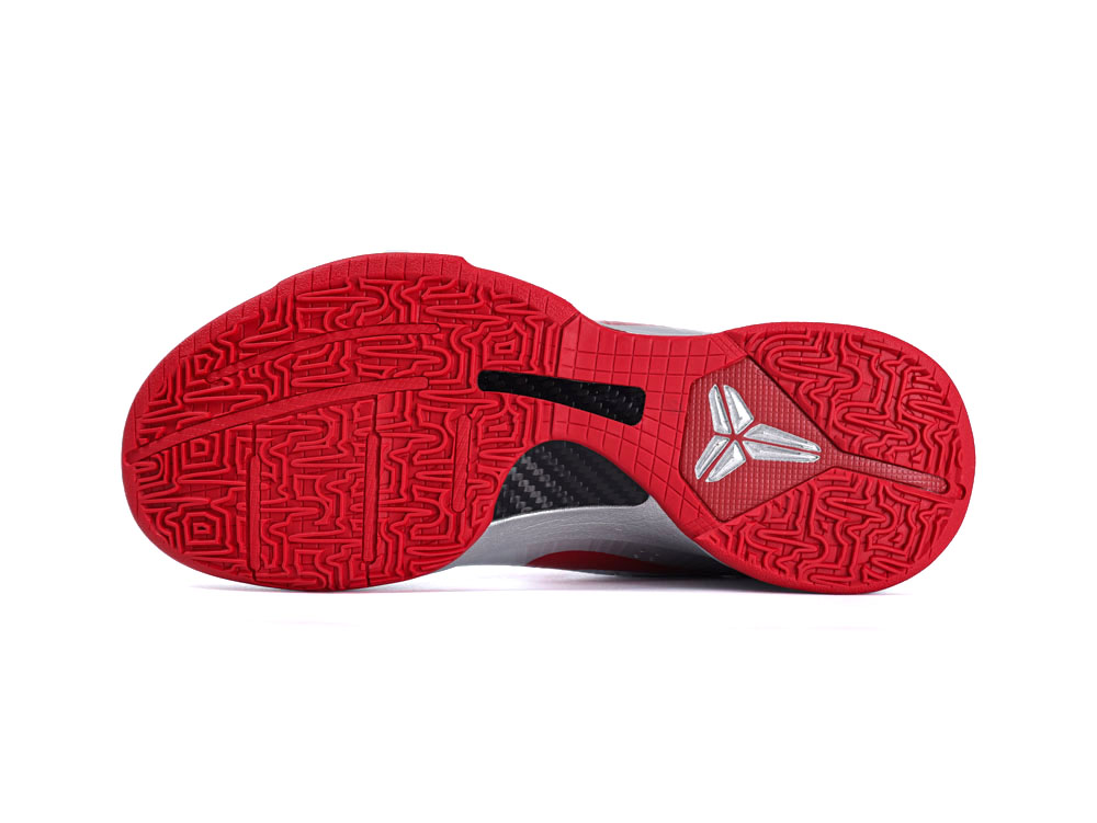 Red rubber shoe sole with intricate pattern and carbon fiber shank detail.