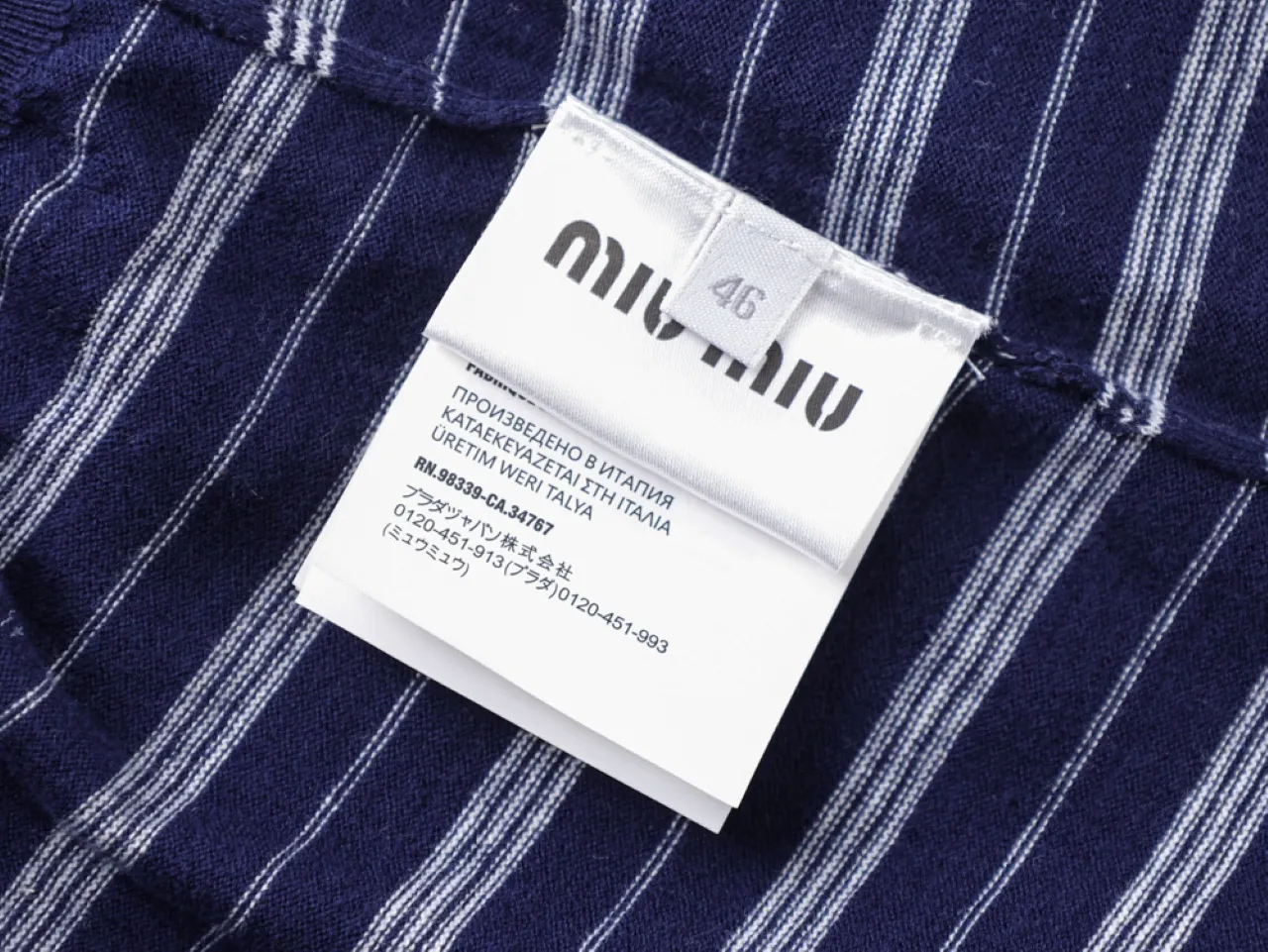 Blue and white striped fabric with a white clothing label attached.