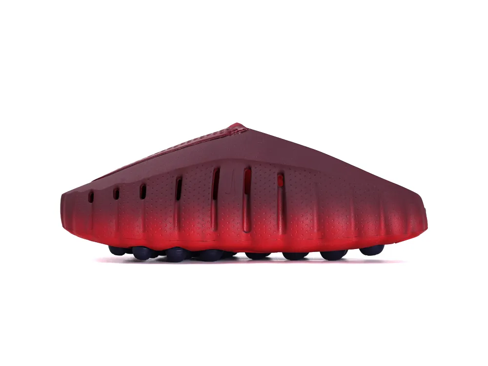 Side profile of the right shoe highlighting the vertical ventilation slits and the red outsole with navy pods.