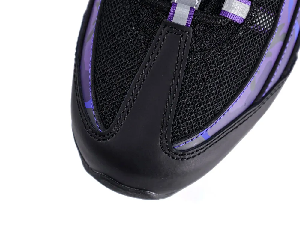 Close-up of a black and purple sneaker toe made of mesh and leather.