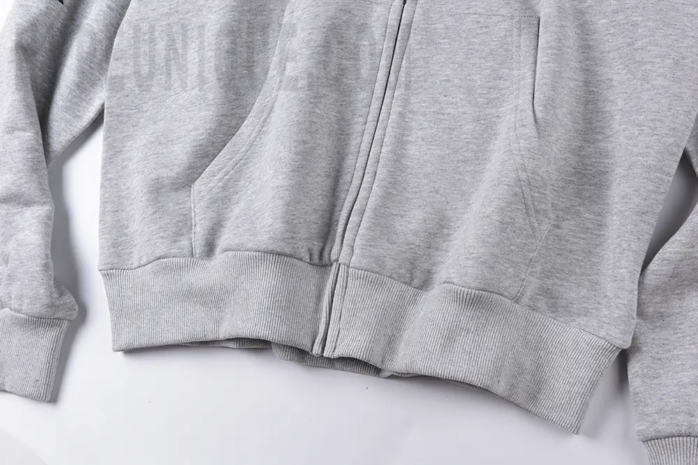 GloGang Four-Way Arrow Hoodie Grey hem and zipper detailing shown.