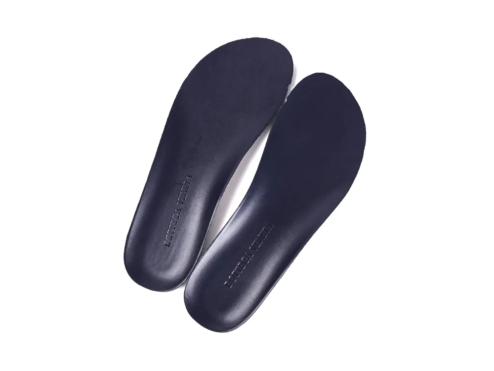 Dark blue leather insoles with embossed branding, designed for footwear comfort and support.