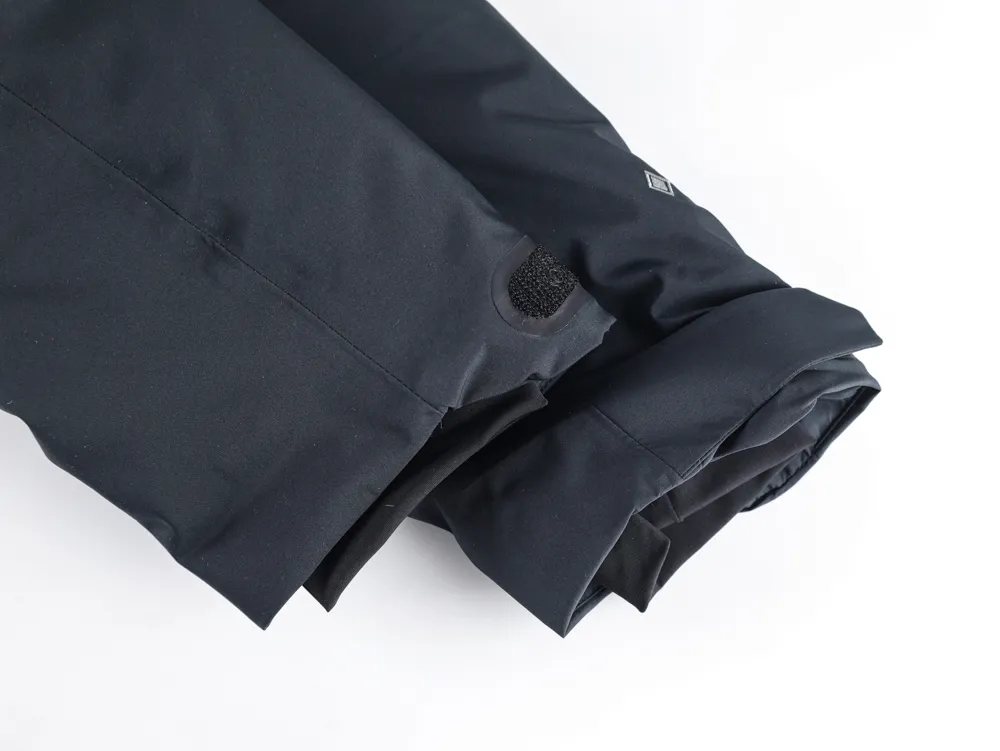 Jacket sleeve with strap and cuff detail.