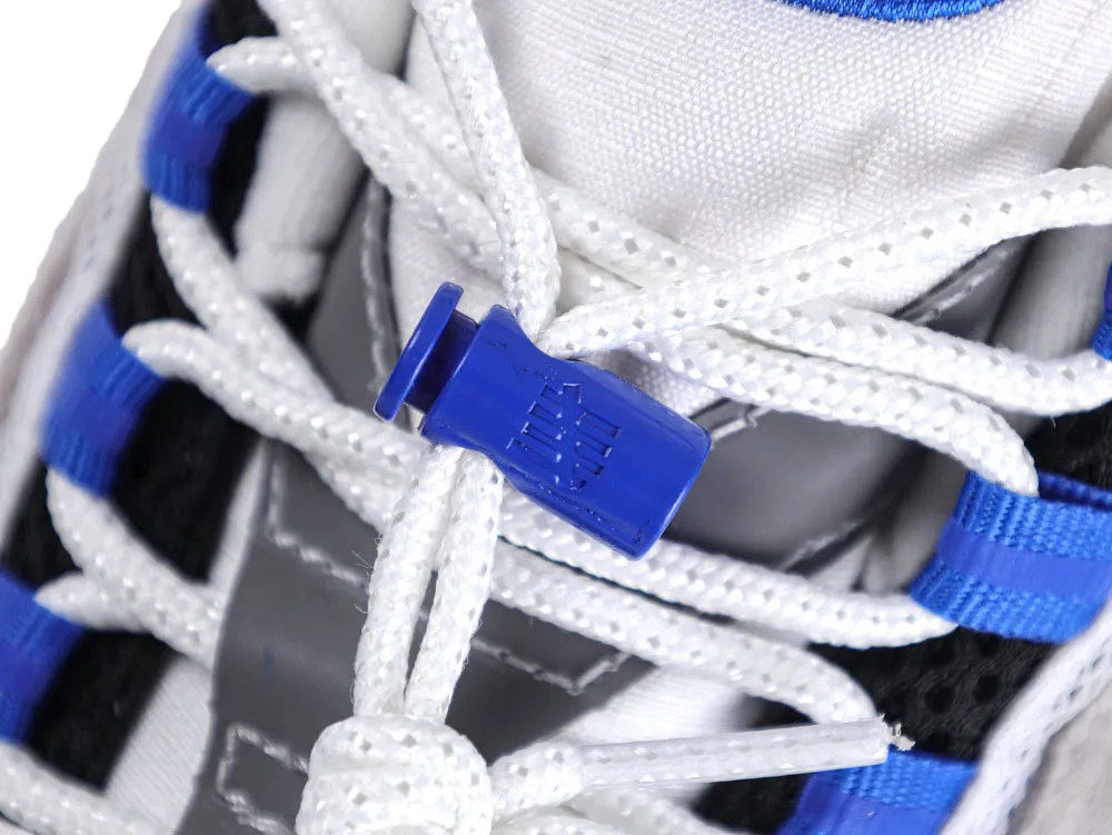 White and blue shoelaces with a plastic toggle on a sneaker.