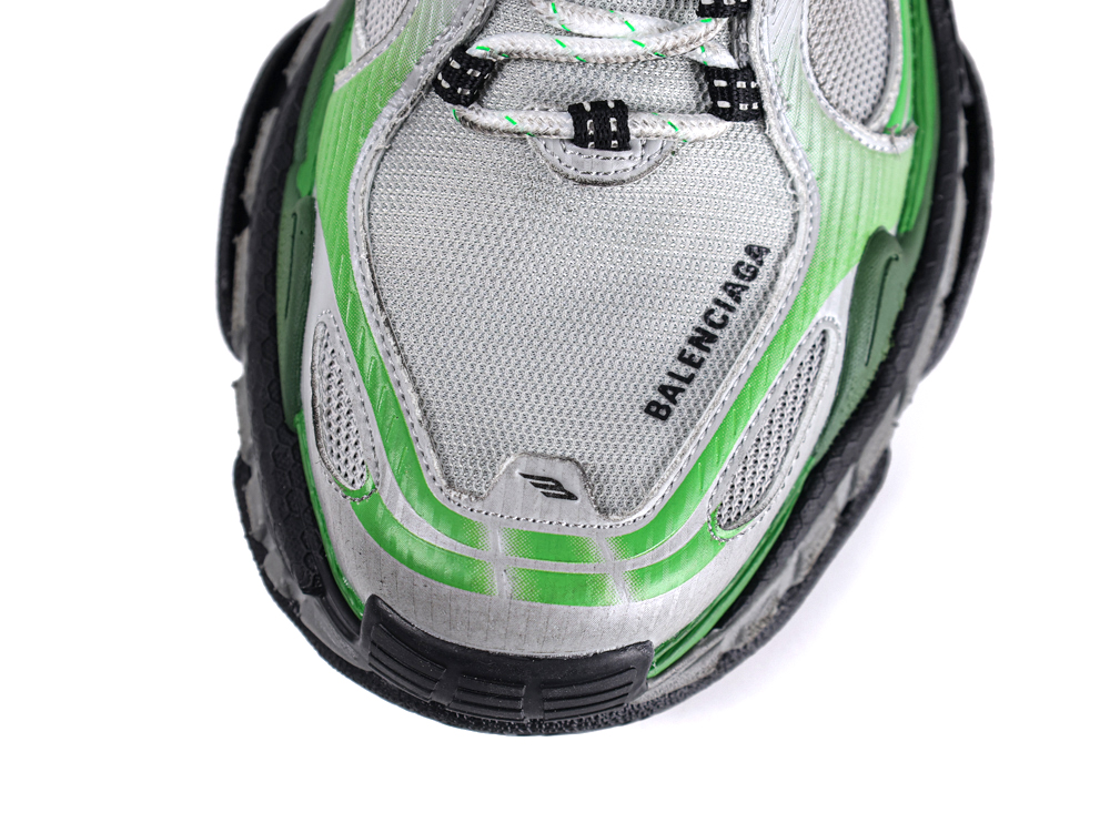 Green and silver mesh sneaker with black sole, detailed logo on the side.