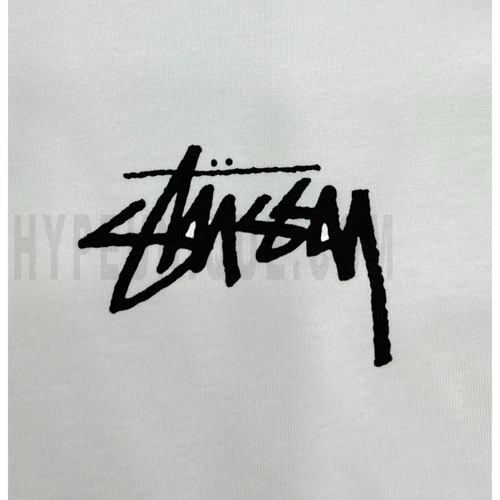 Detailed shot capturing the graphic print on the white tee's front panel.