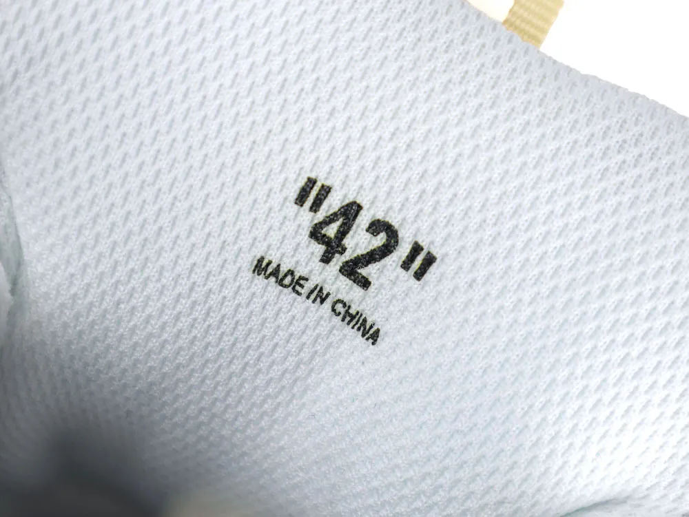 White mesh shoe interior with black print, indicating size "42", made in China.