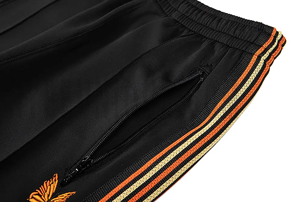 Close-up detail of the track pants pocket.