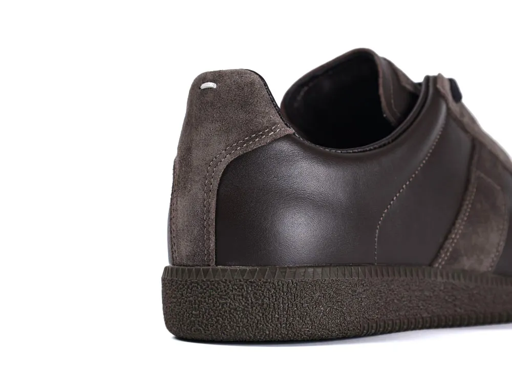Brown leather and suede shoe with textured rubber sole, showing back and side.