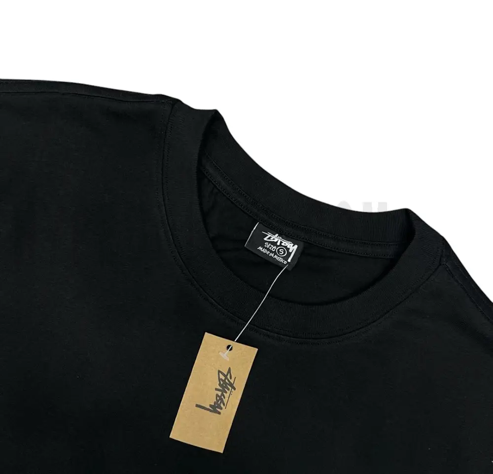 Neckline tag close-up, displaying garment care symbols and brand information with fashion-forward presentation.