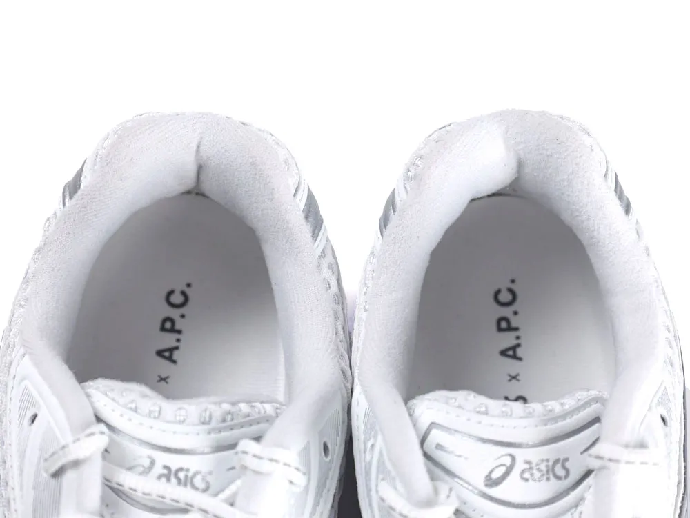 White sneakers with fabric lining and brand logos inside the shoe collar.