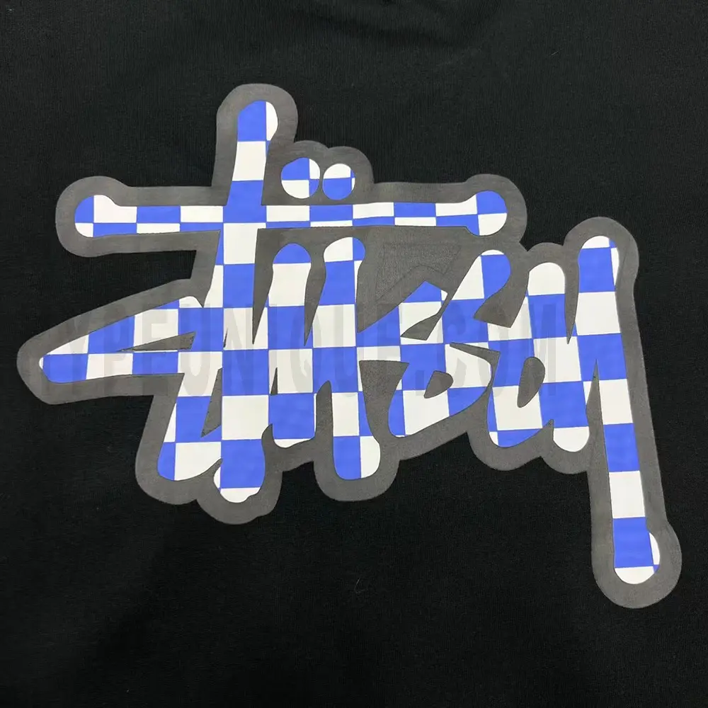 Close-up of the T-shirt print details of the black clothes.