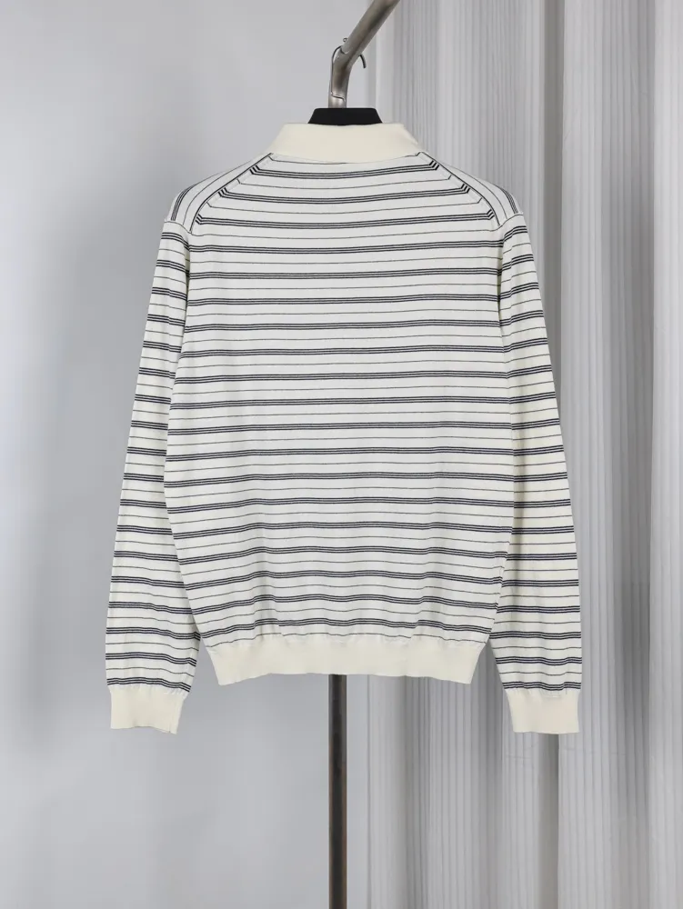White and navy striped sweater made of cotton, featuring a ribbed collar and cuffs.