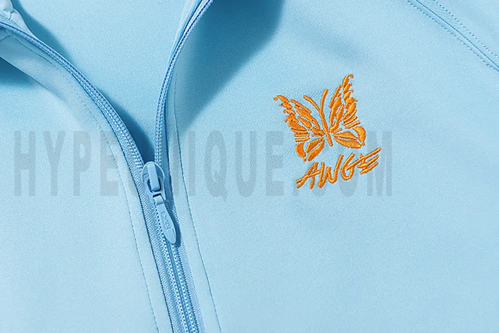 Close-up of butterfly embroidery detail on the chest of the jacket.