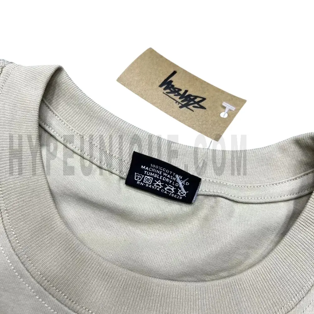 Neckline tag close-up, displaying garment care symbols and brand information with fashion-forward presentation.