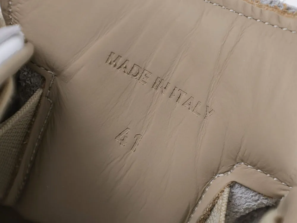 Beige leather interior of a shoe with "Made in Italy" embossed.