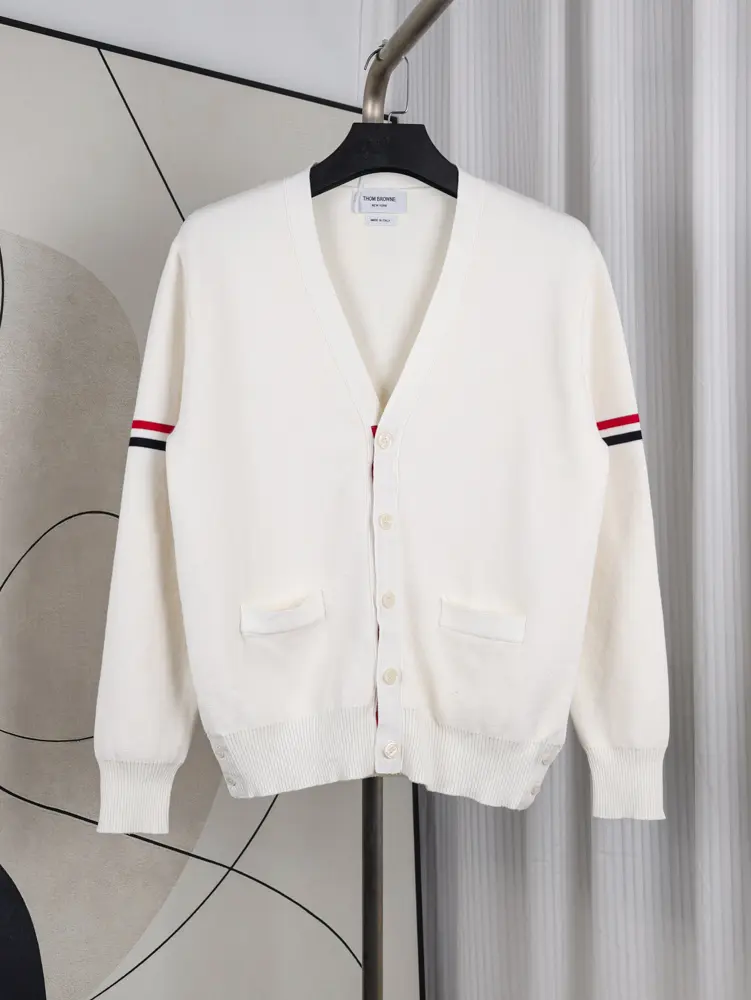 A front view of the Fine Merino Wool RWB Armband Cardigan in white, showcasing its white merino wool material.
