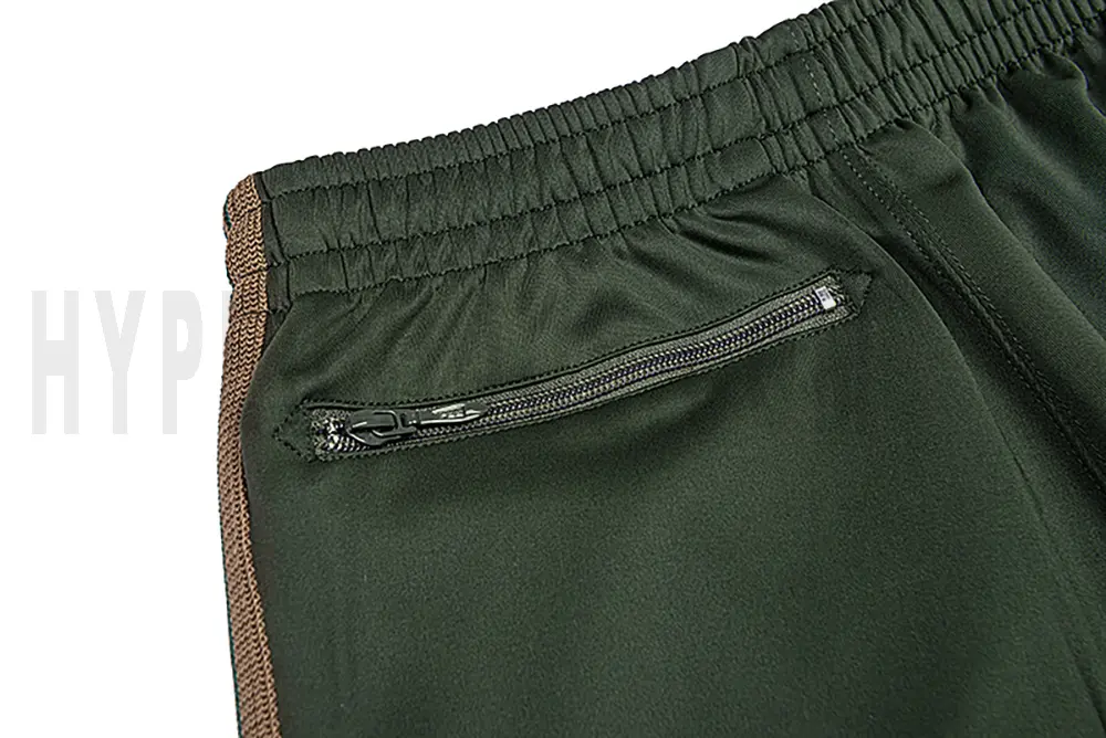 Detail of the back zip pocket on the track pants.