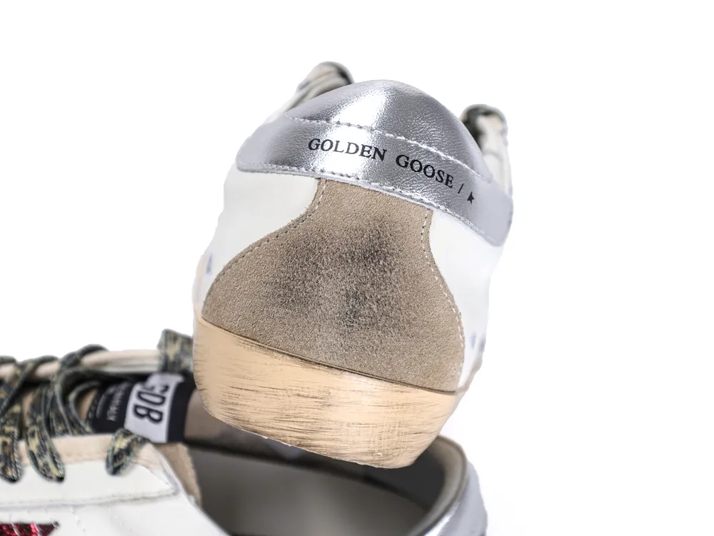 Rear view of Golden Goose sneaker with silver heel tab and grey suede