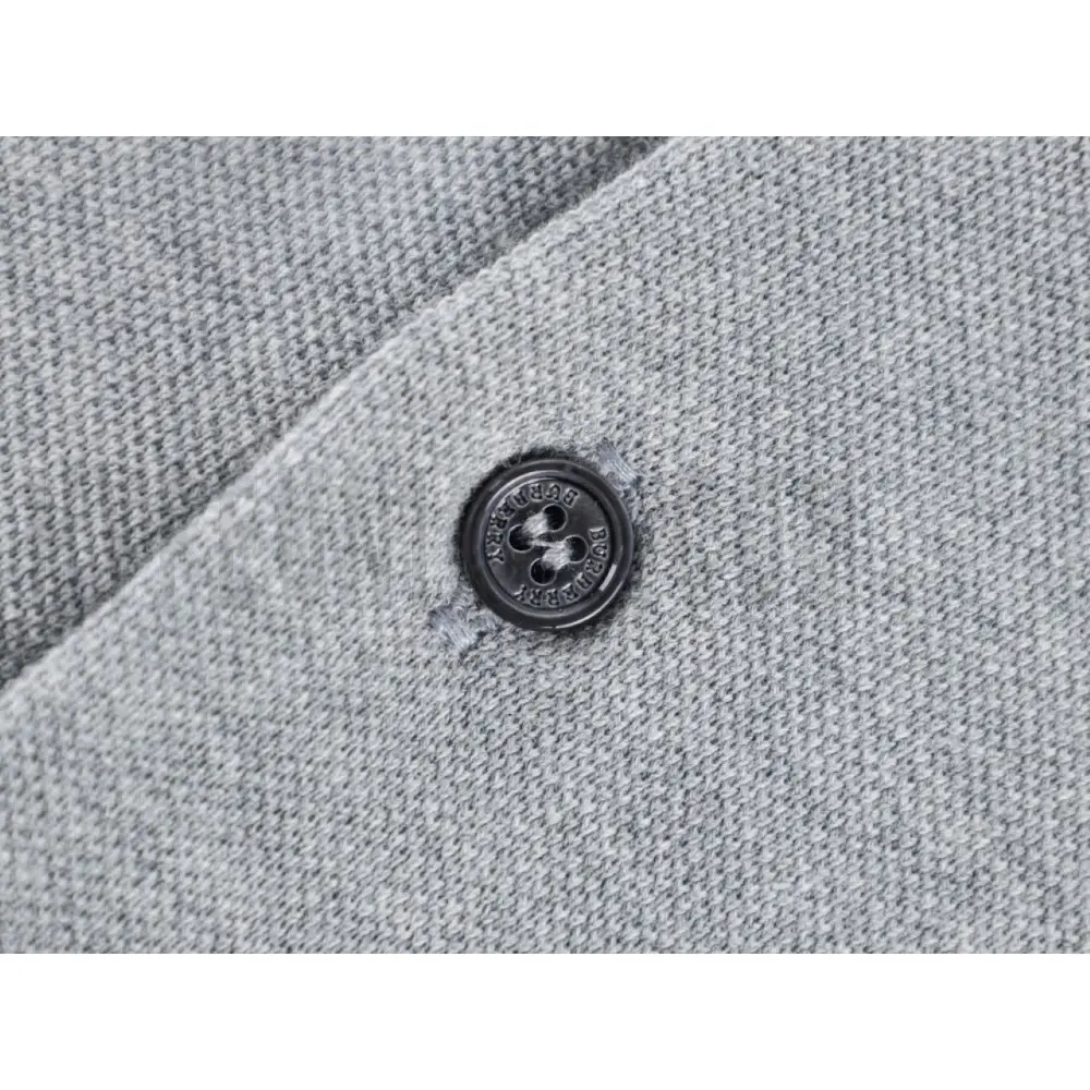Close-up of button detail on the garment