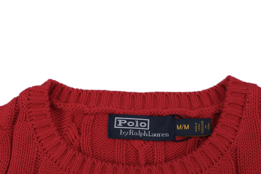 Red cotton sweater collar with knitted texture and brand label.