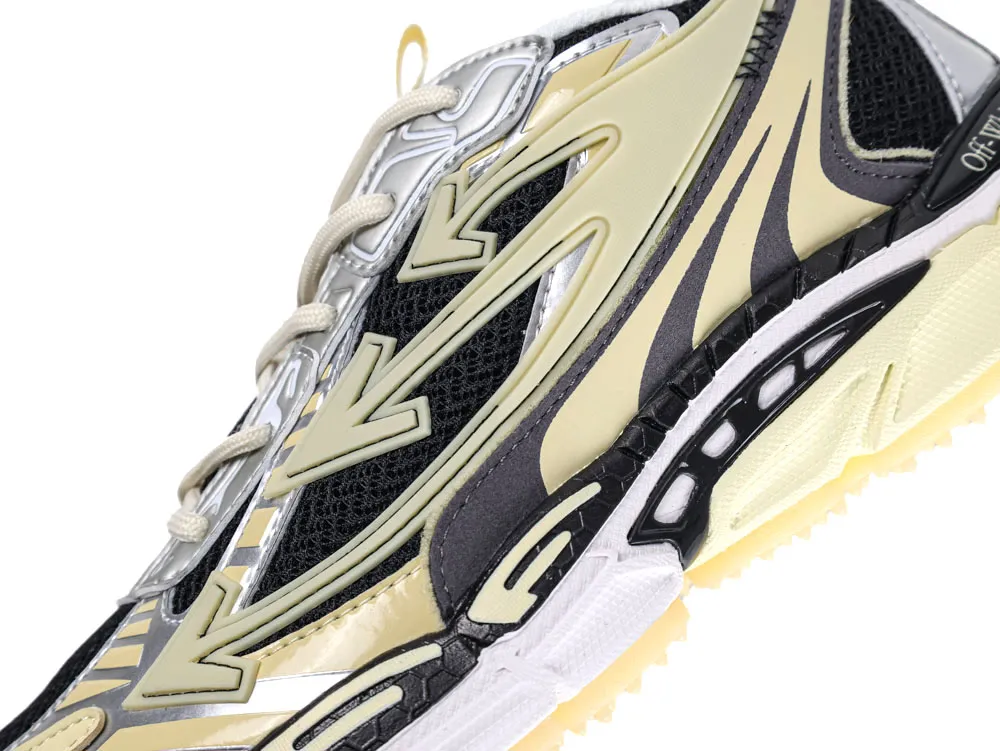 Cream and black sneaker with mesh detailing and textured sole, close-up view.